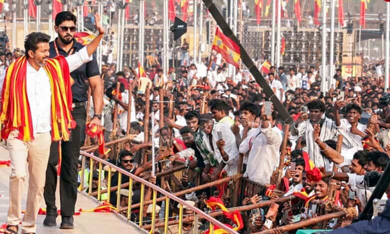 Tamilaga Vettri Kazhagam (TVK) chief and actor Vijay greets his supporters at a massive rally in Madurai
