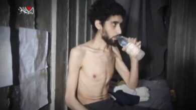 Emaciated Israeli hostage seen drinking water inside a dimly lit concrete tunnel in Gaza, appearing weak and malnourished.