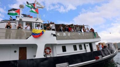Participants aboard the Global Sumud Flotilla wave Palestinian flags as they depart from the Port of Barcelona to break the Israeli siege on Gaza.