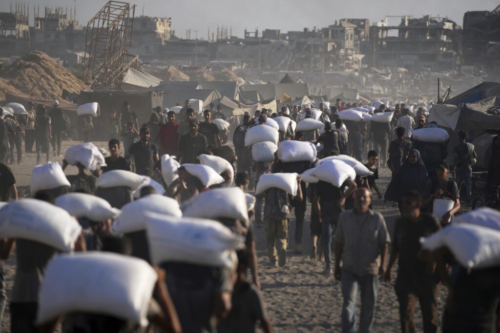 Palestinians collect humanitarian aid 