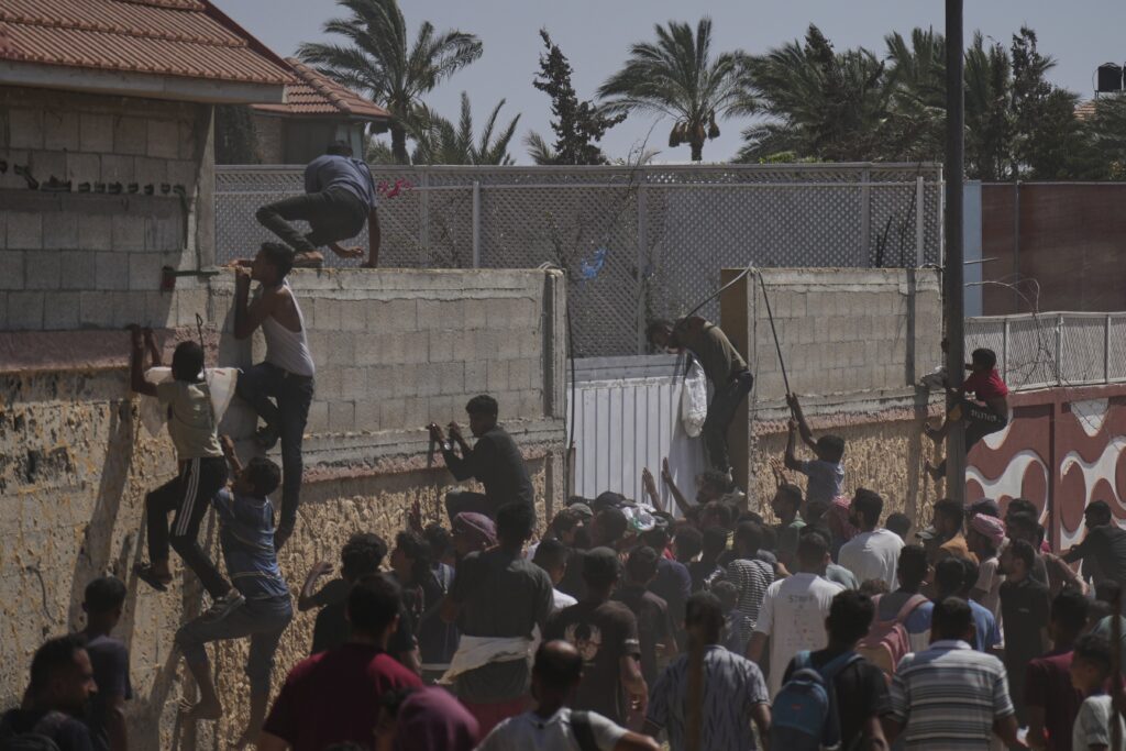 Palestinians collect humanitarian aid