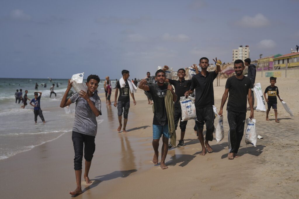 Palestinians collect humanitarian aid