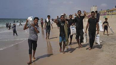 Palestinians collect humanitarian aid