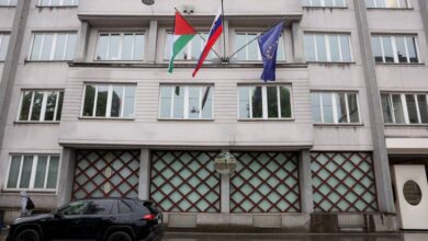 The Palestinian, Slovenian, and European Union flags are seen flying outside a government building in Ljubljana, Slovenia.