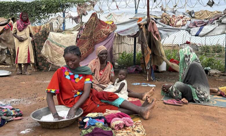 Women wash clothes at Renk transit centre sheltering Sudan war refugees, South Sudan, August 2025.