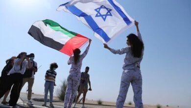 Israeli and Emirati flags waved during Dubai photo shoot symbolising UAE-Israel ties after Abraham Accords.