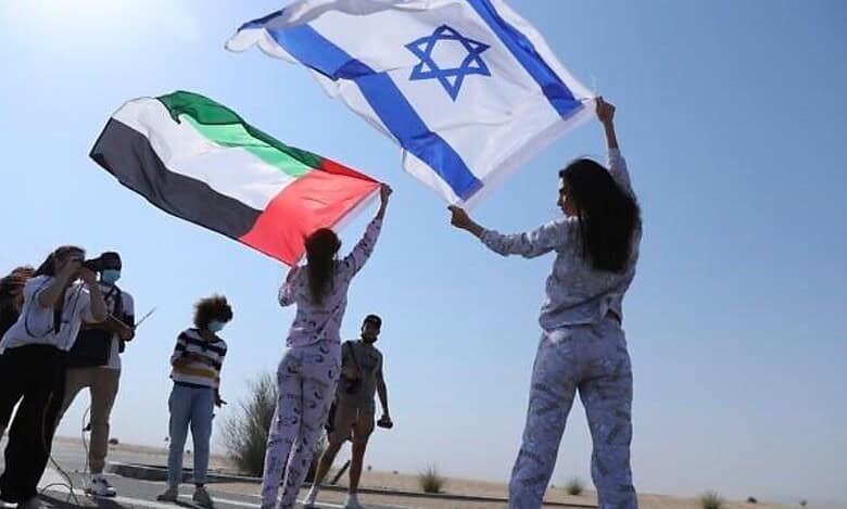 Israeli and Emirati flags waved during Dubai photo shoot symbolising UAE-Israel ties after Abraham Accords.