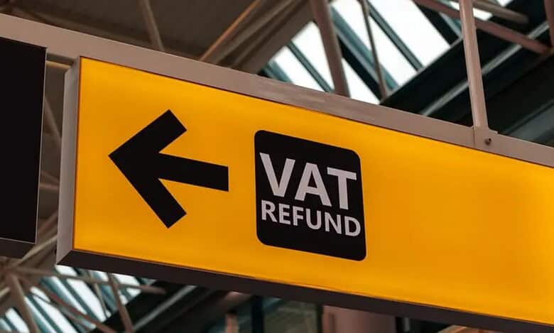 A yellow sign with an arrow pointing to vat return.