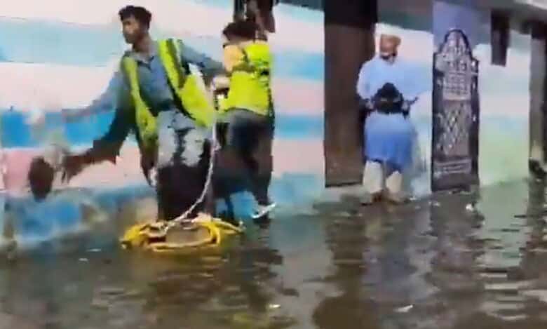 The image shows GHMC officials extending help to those whose houses were flooded near Chaderghat, after around 10,000 cusecs of water was released from Osman Sagar and Himayat Sagar on Friday, September 26, 2025.