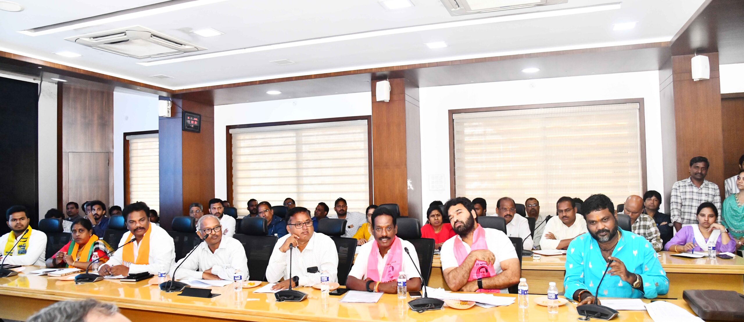 Image of GHMC commissioner and Hyderabad DEO RV Karnan with political party representatives at a meeting for the Jubilee Hills by election.