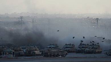 Israeli tanks covered in smoke after shelling