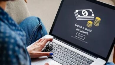A person using a laptop with a screen displaying a "Open a bank account".