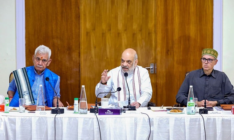 Union Home Minister Amit Shah, Jammu and Kashmir Lt. Governor Manoj Sinha and state CM Omar Abdullah during a meeting over the flood situation at Raj Bhawan in Jammu on Monday (PTI Photo)