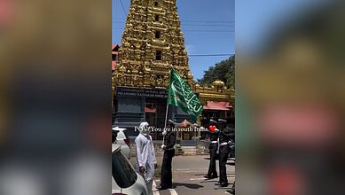 Muslim youth, dressed in uniform, salute a temple during the Eid-e-Milad rally in Kerala