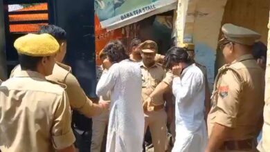 Young Muslim men, holding their ears, being taken into a police vehicle in Uttar Pradesh's Ferozabad