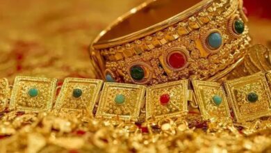 Exquisite gold jewelry with colored gemstones, traditional and luxurious, showcased on a rich surface.