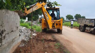 Boundary wall on a government land being demolished in Shamshabad