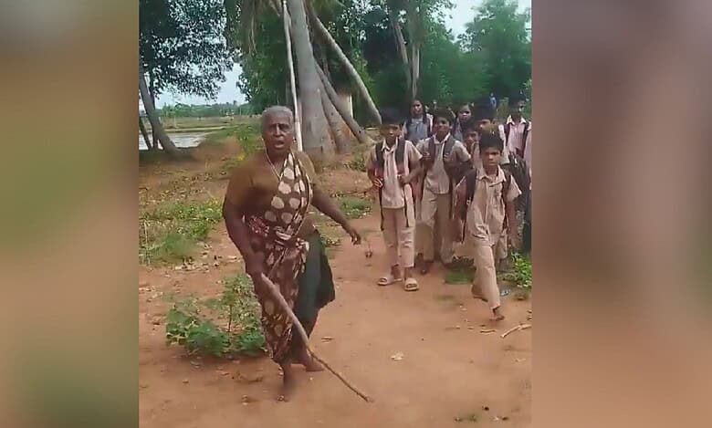 An elderly upper caste woman blocks school going children from the Dalit community from using a path. The incident occurred in Tamil Nadu