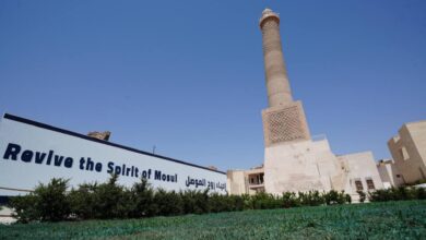 Restored al-Hadba minaret of Mosul’s al-Nuri mosque with a banner reading “Revive the Spirit of Mosul.”