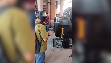Woman drives car out of showroom's first floor in Delhi