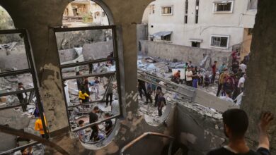 Palestinians gather among rubble after an Israeli airstrike in central Gaza.