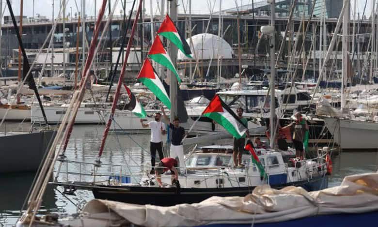 Activists on a boat wave Palestinian flags as part of the Global Sumud Flotilla.