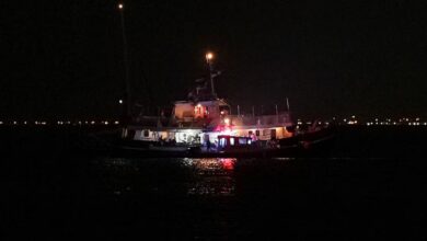 Global Sumud flotilla vessel illuminated at night during inspection by Tunisian Maritime National Guard boats in Sidi Bou Said.