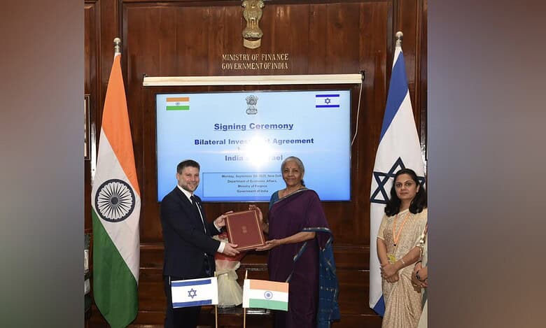 Indian Finance Minister Nirmala Sitharaman and Israeli Finance Minister Bezalel Smotrich exchange documents.