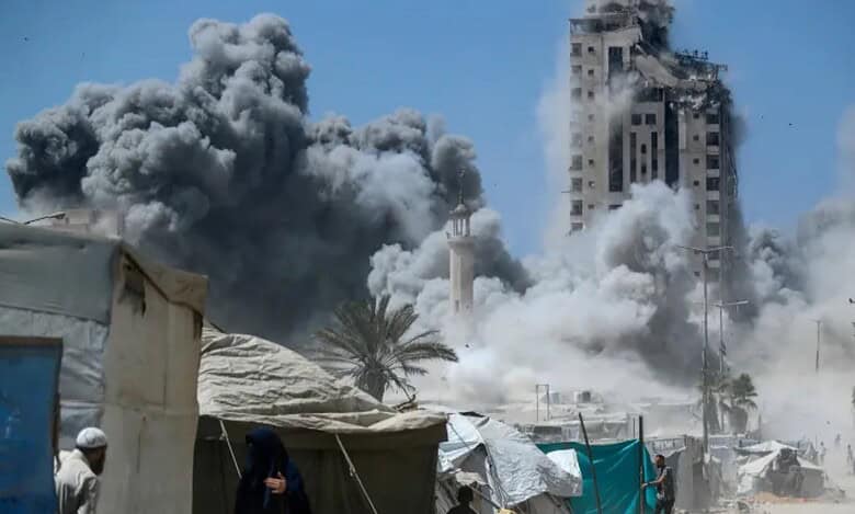 Smoke billows as a high-rise collapses after an Israeli air strike in Gaza City.