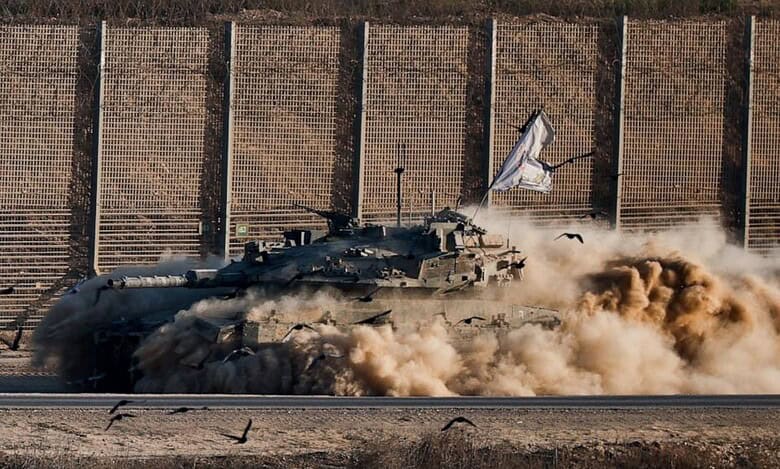 Israeli tank manoeuvring near the Gaza border, raising dust and flying a flag, September 17, 2025.