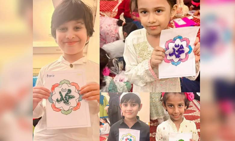 Children displaying artwork with the name Muhammad written in Arabic at the Know Your Prophet workshop.