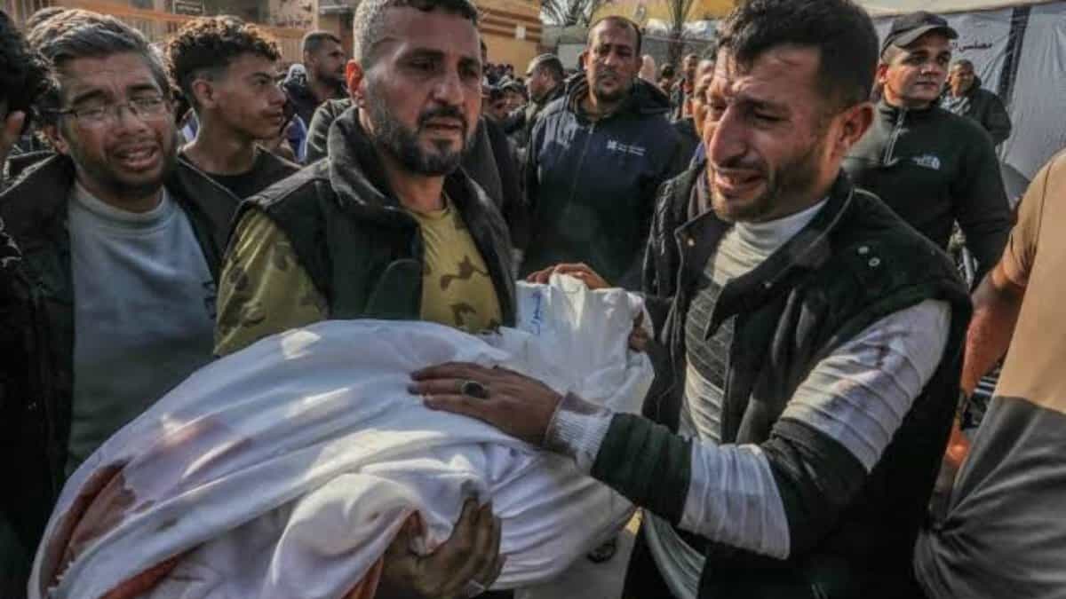 Grieving Palestinian men carry the body of a child killed in an Israeli strike in Gaza.
