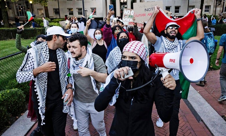 Pro-Palestinian demonstrators protest with keffiyehs and signs at Columbia University, New York, on October 12, 2024.