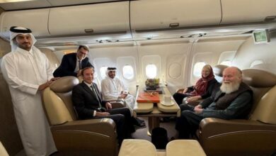 Qatari officials and diplomats sit with British couple Peter and Barbie Reynolds on a plane after their release from Taliban custody in Afghanistan.