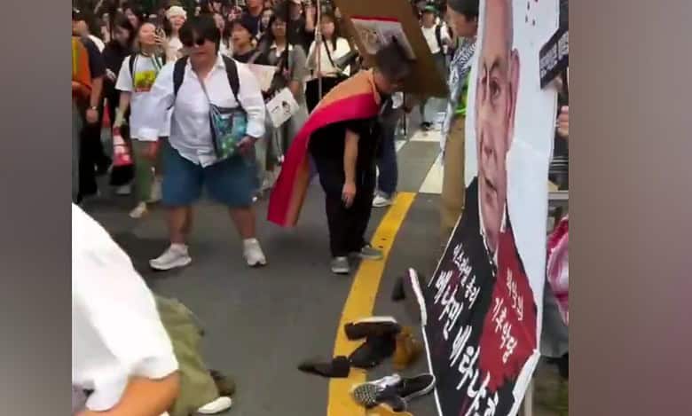 Protesters in Seoul throw shoes at a large poster of Israeli Prime Minister Benjamin Netanyahu during a street demonstration.