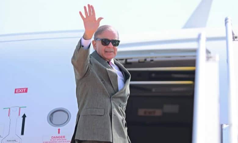 Pakistan Prime Minister Shehbaz Sharif waves before departing for Saudi Arabia.