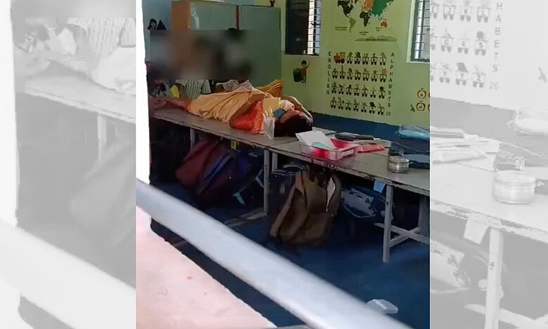 Primary school children massage their principal's legs in Tamil Nadu's Dharmapuri district