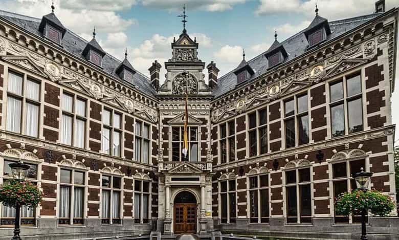 Historic main building of Utrecht University with ornate architecture and symmetrical design.