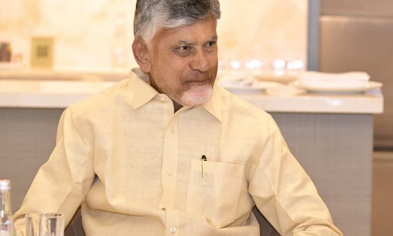Andhra Pradesh Chief Minister N Chandrababu Naidu seated at a table during his UAE visit.
