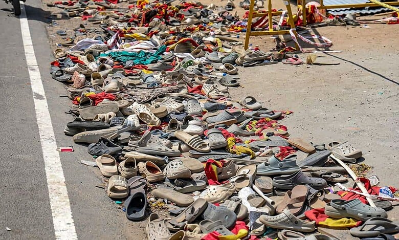 Footwear and other belongings of people lie on a road in the aftermath of stampede in TN