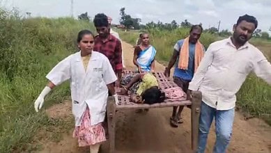 108 ambulance team carry a heavily pregnant Gotti Koya woman on a cot