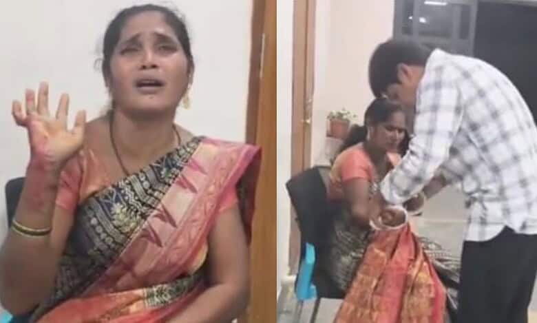 The image shows Gangamani of Bhainsa mandal with her wrist slit, and a medical official giving her first-aid during Prajavani at Nirmal collectorate on Monday, October 13, 2025.