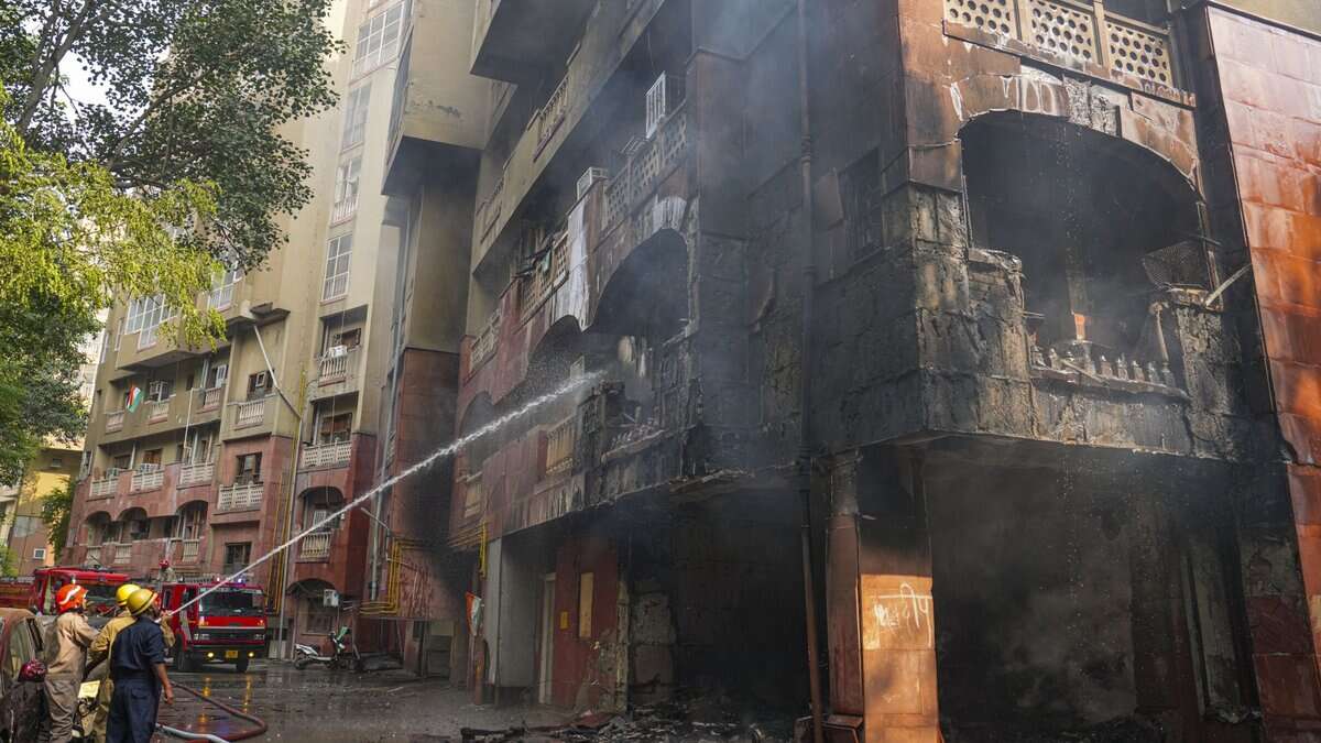 Firefighters try to douse a fire that broke out at Brahmaputra Apartments, in New Delhi on Saturday. The apartment complex houses residences of several Lok Sabha and Rajya Sabha MPs. (PTI Photo/Karma Bhutia)