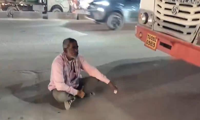 Man sits in front of RTC bus in Hyderabad