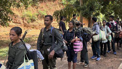 Maoist cadres surrender with weapons before the authorities, in Kanker district, Chhattisgarh, on October 26, 2025. (PTI Photo)
