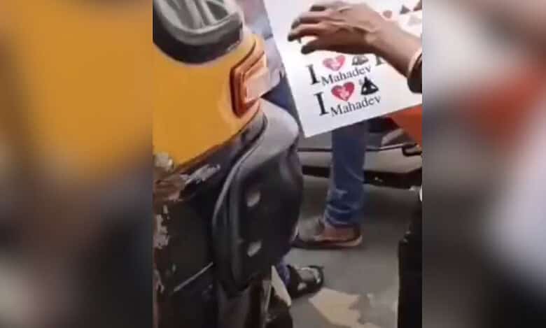 Members of Hindutva organisation stick "I Love Mahadev" on vehicles