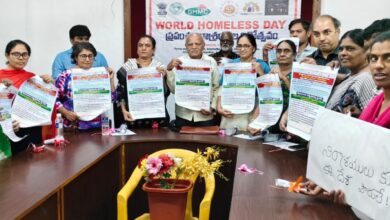 The image shows social activists releasing a poster on the occasion of World Homeless Day meeting held at Sundarayya Vignana Kendram on Friday, October 9, 2025.