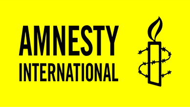 Logo of Amnesty International featuring a candle wrapped in barbed wire on a yellow background.