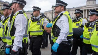 British police officers escort detained protesters during a pro-Palestinian demonstration in Trafalgar Square, London.