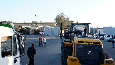 Bulldozers enter the Egyptian side of the Rafah crossing for inspection before entering Gaza following a ceasefire agreement.